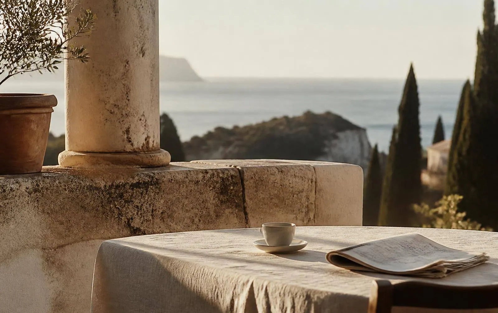 A terrace table set for breakfast in the morning light